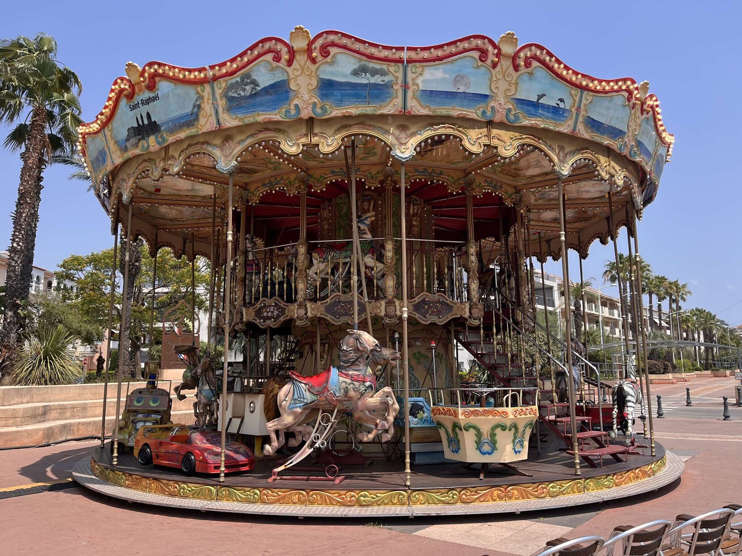 A carousel with ornate decorations and a horse figure in the center.