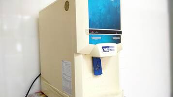 A water dispenser with a blue label, a power button, and a service label for Velken Service.