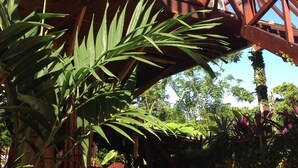 A wooden structure with a balcony, surrounded by greenery. - Casa Estrella Mirabal (Cabarete)