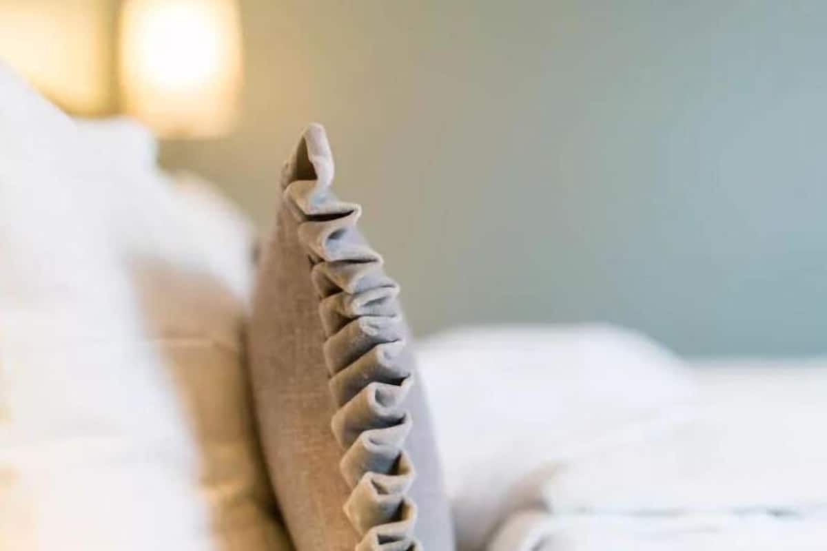 A close-up of a bed's headboard with a textured design.