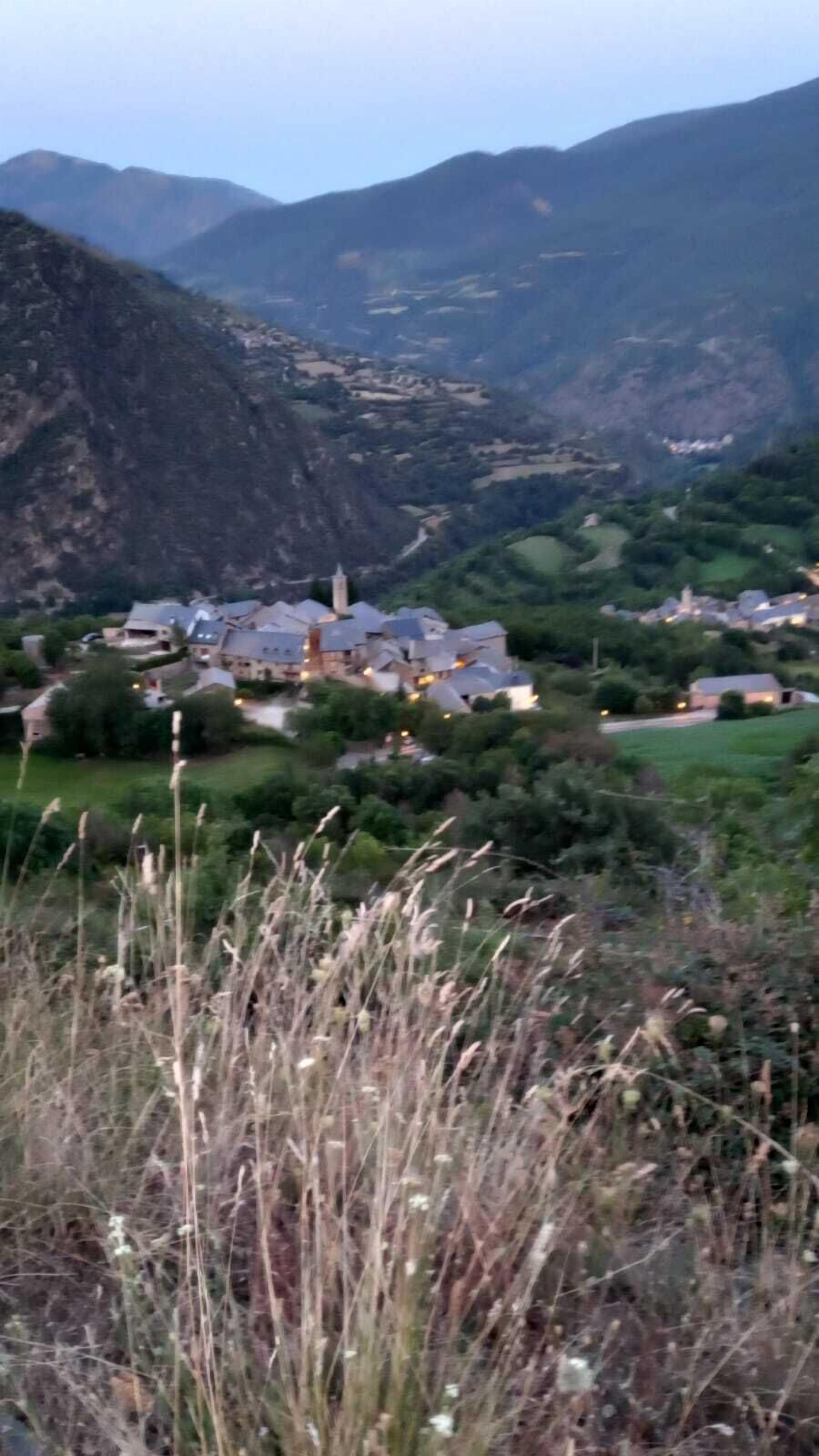 A mountainous landscape with a village and houses.