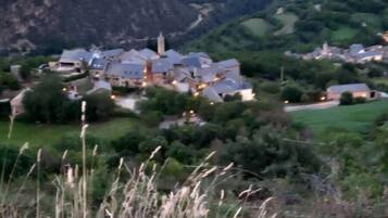 A mountainous landscape with a village and houses.