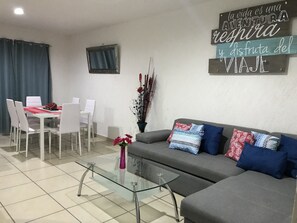 Departamento Deluxe, 2 habitaciones | Área de sala de estar | Televisión de pantalla plana de 42 pulgadas con canales por cable 