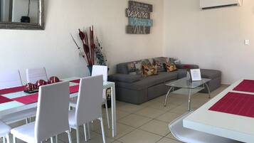 Deluxe Apartment, 2 Bedrooms | Living area | 42-inch flat-screen TV with cable channels, TV