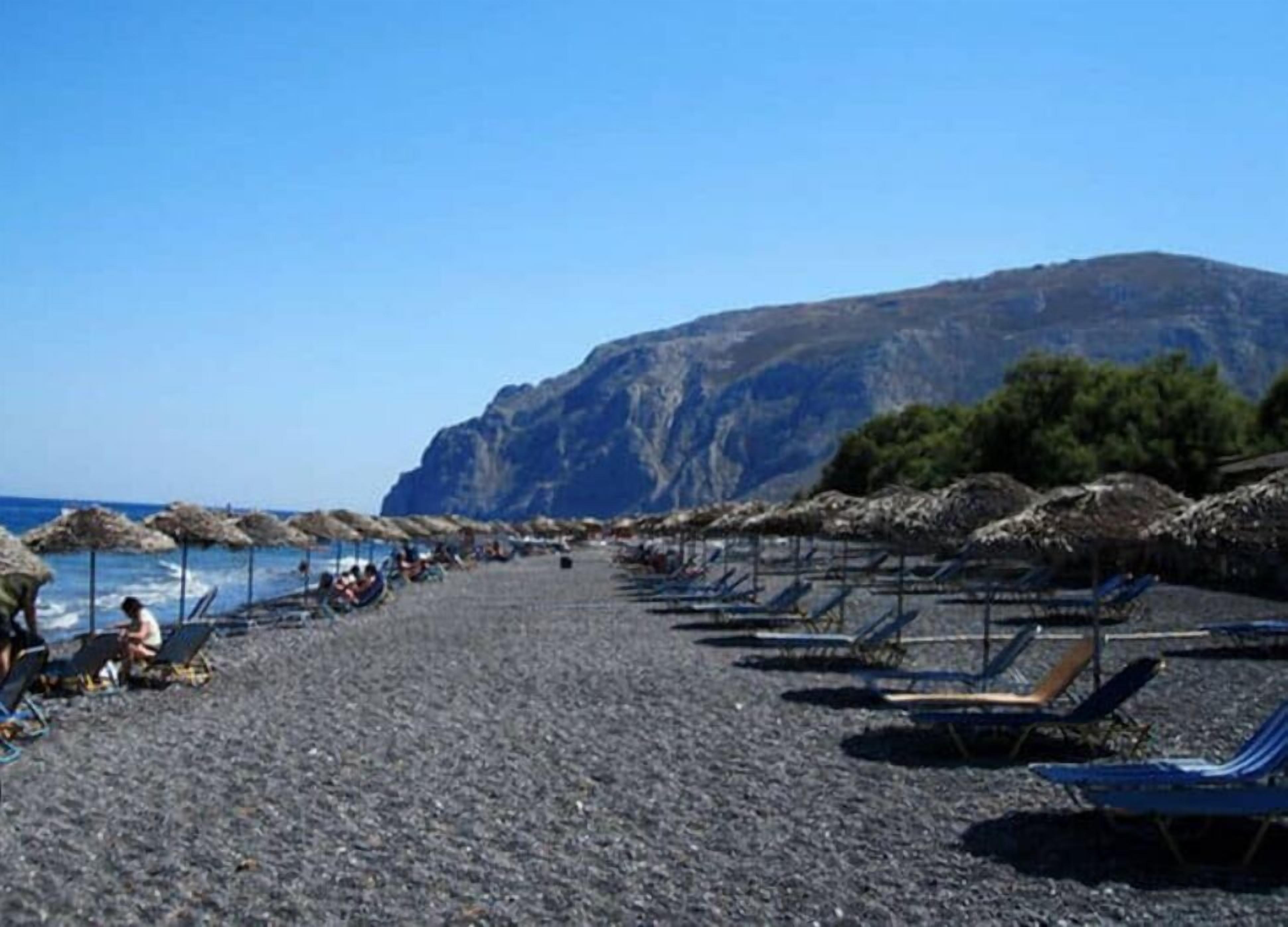 on the beach, black sand, motor boating, rowing