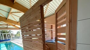 A wooden partition with a pool in the background.