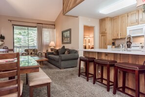 Cozy living space with a kitchenette, dining area, and comfortable sofa.