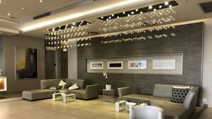 A modern living room with sofas, coffee tables, and decorative lighting. - Sandton Skye Suite 604 (Sandton)