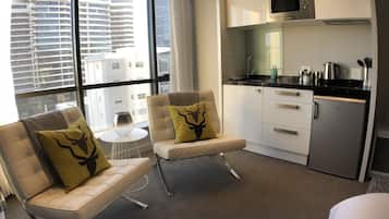 Luxury Studio Suite, 1 King Bed, City View | Living area | Flat-screen TV