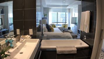 Luxury Studio Suite, 1 King Bed, City View | Bathroom | Separate tub and shower, free toiletries, hair dryer, bathrobes