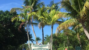 A sign for Tigertail Beach Park with a stop sign nearby. - Beautiful Water Views, 7-min Walk to Tigertail Beach entrance, 5 bikes, Hot Tub (Marco Island)