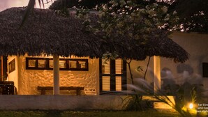 A thatched-roof structure with a sign reading "LA CUEVA ECO LODGE." - La Cueva Eco-Lodge (Las Galeras)