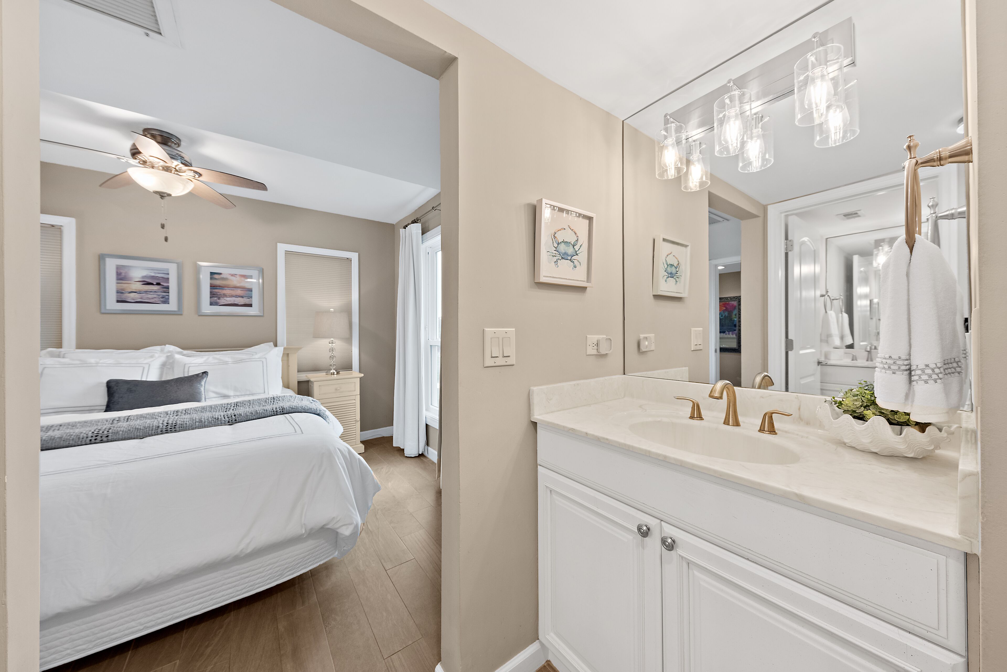 A bedroom with a bed, a nightstand, and a ceiling fan.