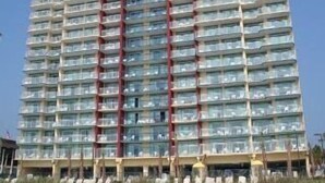 A tall, multi-story hotel with a modern design, featuring balconies on each floor. - 25 ft. Balcony Oceanfront ! Incredible views !MONTHLY WINTER RENTAL AVAILABLE ! (Myrtle Beach)
