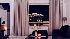 A living room with a view of a historic building at night. - Acropolis front row loft,please watch video (Athens)