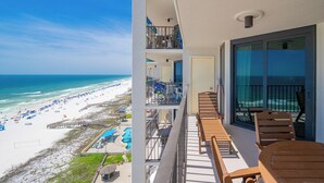 A balcony with a view of the beach, pool, and ocean.