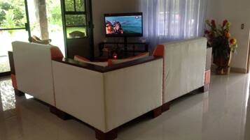 Deluxe House, 3 Bedrooms | Living room | Flat-screen TV