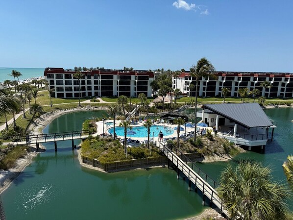 A resort with a swimming pool, a bridge, and a beach area. - Penthouse on the beach,Rooftop Deck FOR FAB Sunsets & 360 Views, 2 MIN to Beach! (Sanibel)