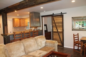 Relax in this inviting space with a sofa, coffee table, and kitchen area.