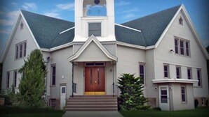 A large, white building with a prominent tower and a central entrance.