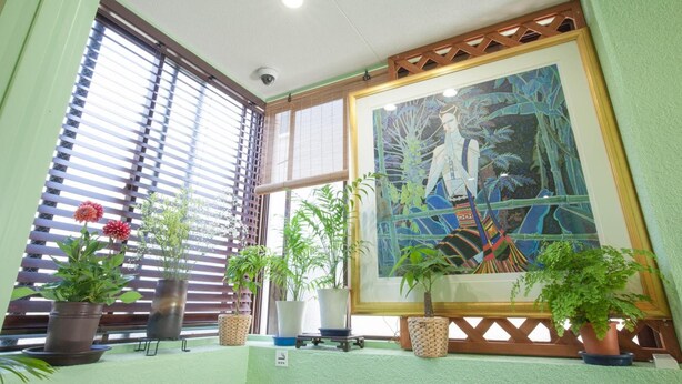 A room with large windows, a framed painting, and several potted plants. - Akasaka-no Sato - Caters to Women - Hostel (Tokyo)