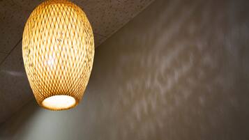 A woven light fixture hanging from a ceiling.
