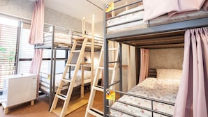 A dormitory room with bunk beds, a desk, and a window with blinds. - Akasaka-no Sato - Caters to Women - Hostel (Tokyo)