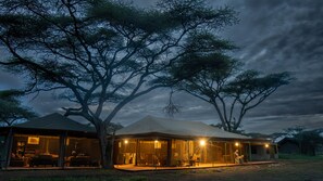 A safari lodge with a large open dining area, a bar, and a seating area. - Angata Migration Camp (Serengeti)