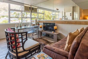 Design Studio Suite, 1 Bedroom, Mountain View | Living area | 38-inch flat-screen TV with premium TV channels, TV - Montclaire Suite 3 (Cape Town)