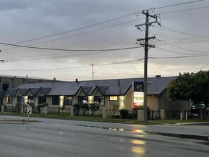 A motel with a sign indicating 'Tudor House' and 'Motel' with a 'Keep Left' sign. - Tudor House Motel (Shepparton)