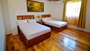 A hotel room with two wooden beds, a painting on the wall, and a window with curtains. - Casa Simeon (Bacacay)