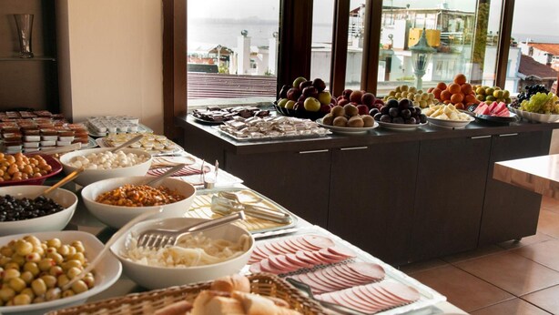 A buffet with various food items including fruits, cheeses, and bread. - Mevlana Hotel (Istanbul)