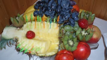 A fruit arrangement on a table with a wooden background.
