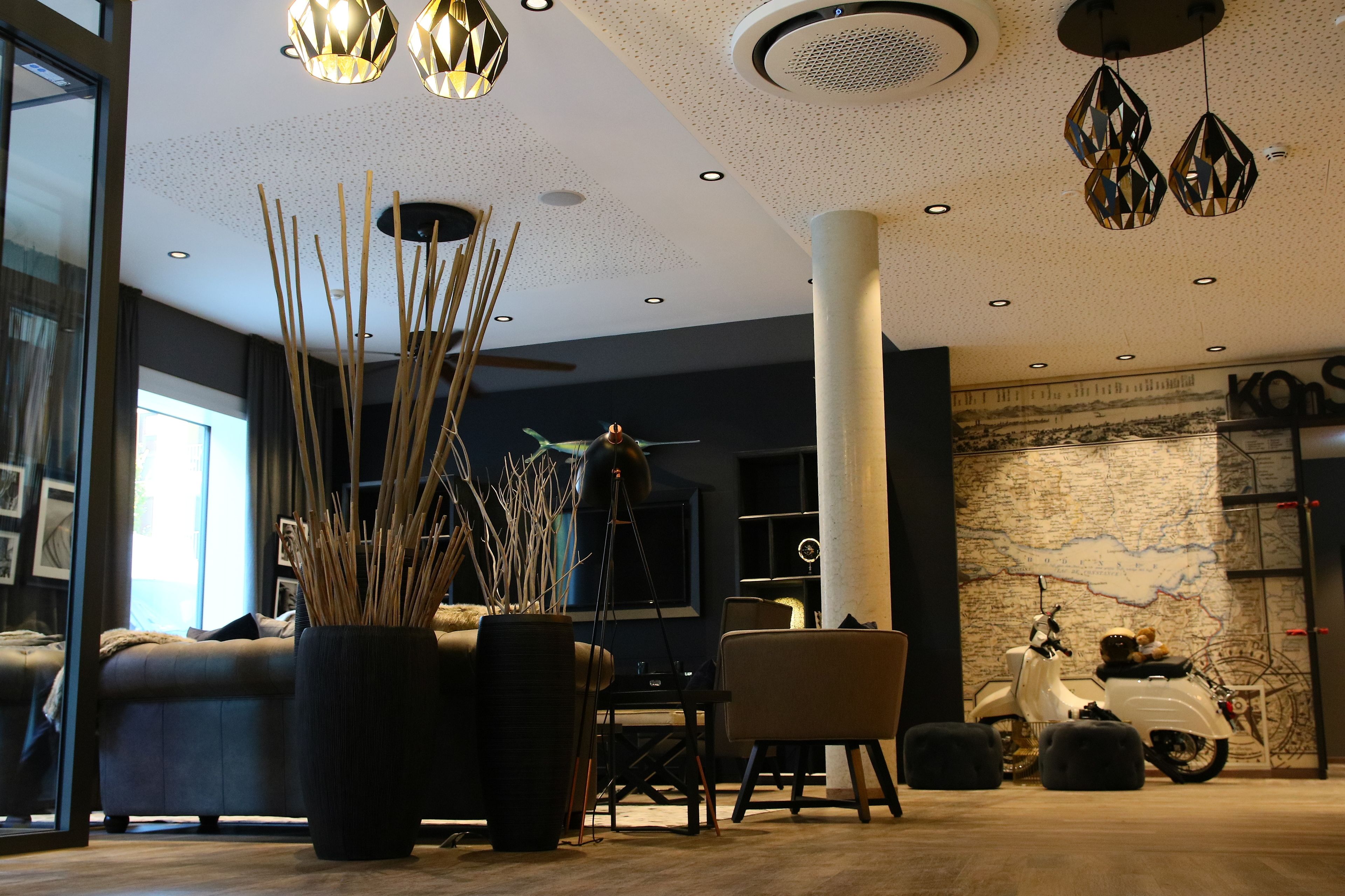 A modern interior with a sofa, a dining table, and a map on the wall.