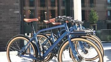 A row of bicycles parked in front of a building with a sign that reads "HARBOR hotel".