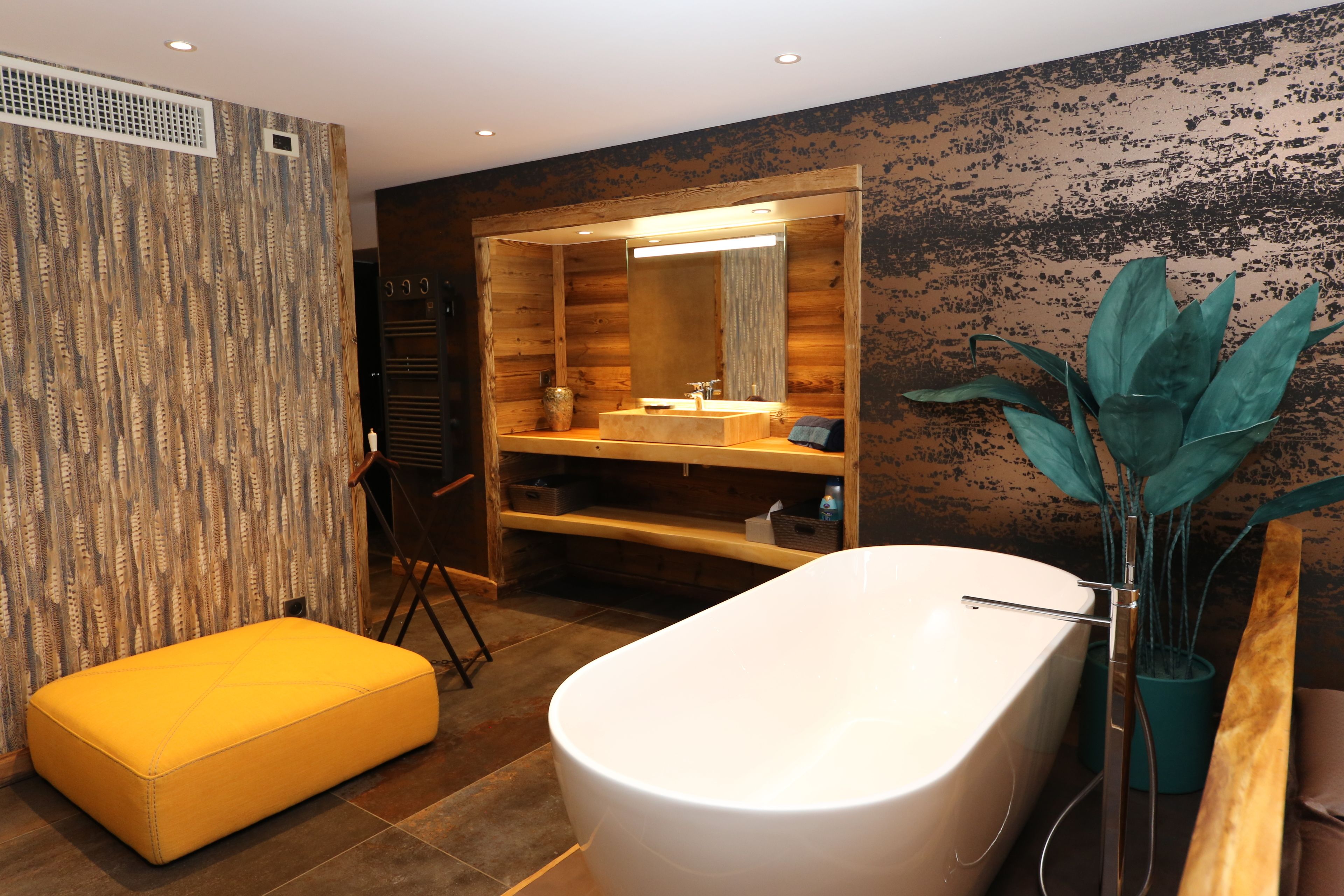 A modern bathroom with a freestanding bathtub, wooden paneling, and a large mirror.