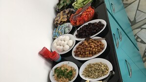A buffet table with various food items including fruits, vegetables, and cheeses. - Pinar Motel 2022-33-0198 (Aydincik)