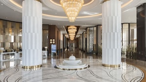 A spacious lobby with a central fountain, high ceilings, and large chandeliers. - Elite World Grand Istanbul Kucukyali  (Istanbul)