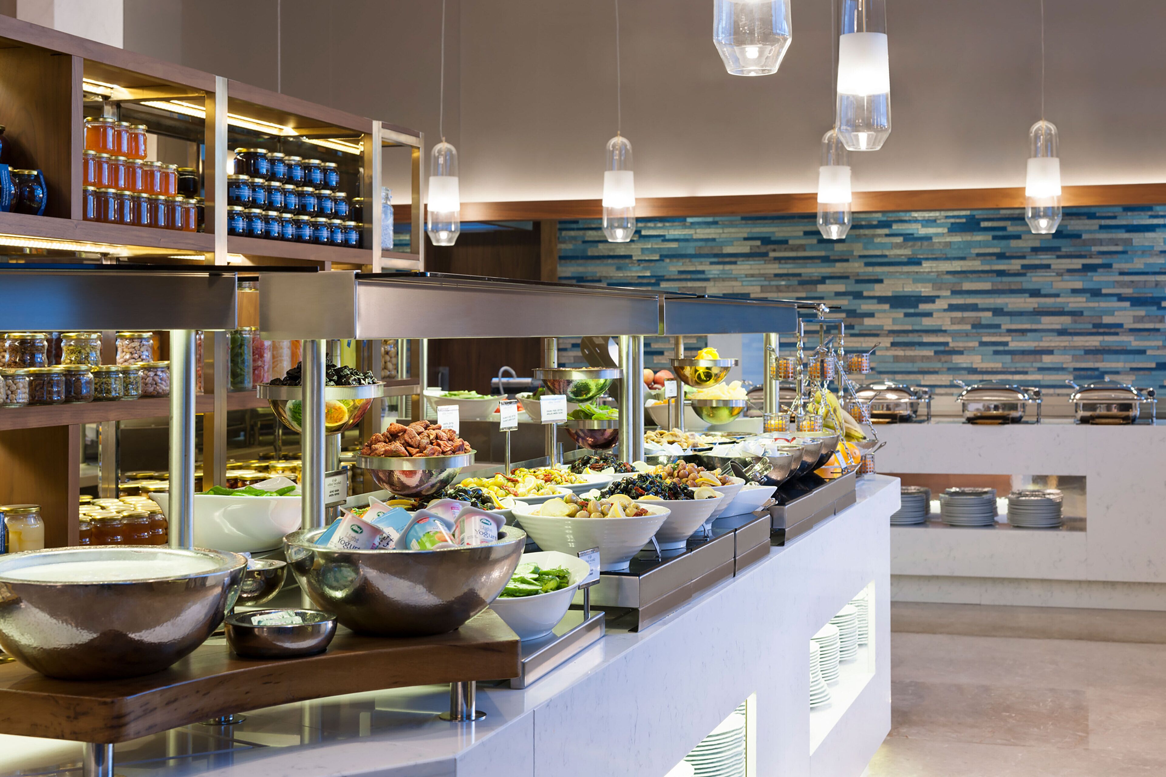 A buffet with various food items and condiments.