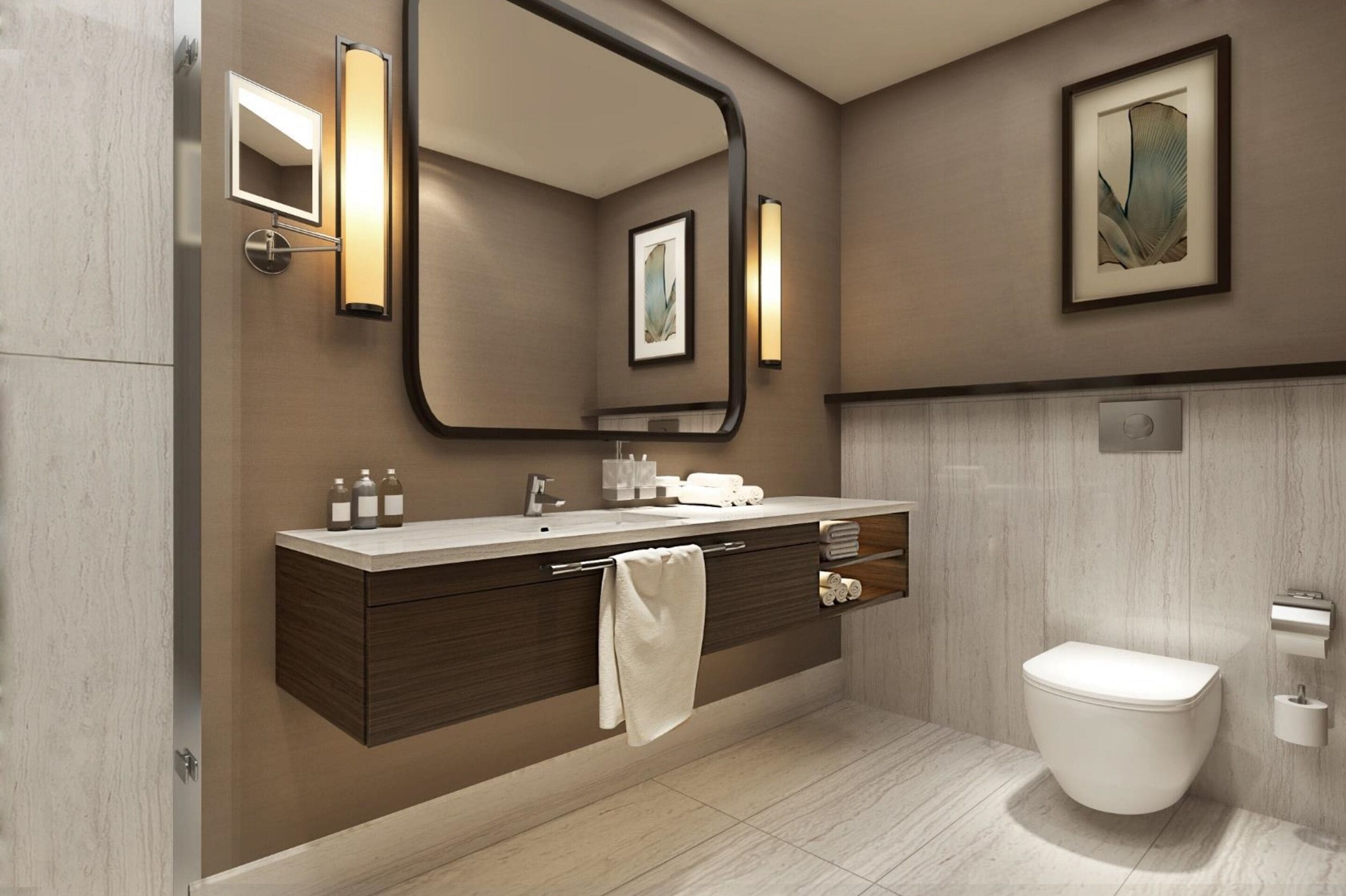 A modern bathroom with a large mirror, a vanity with a towel, a toilet, and a framed artwork on the wall.