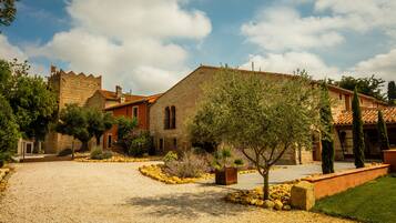 Traditional stone building with a classic entrance, surrounded by well-maintained landscaping and a serene environment.