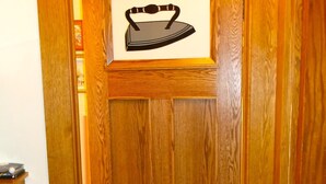 A wooden door with a framed picture of an iron. - Old Iron Inn Bed and Breakfast (Caribou)