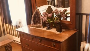 A wooden dresser with drawers and a mirror above it. - Old Iron Inn Bed and Breakfast (Caribou)