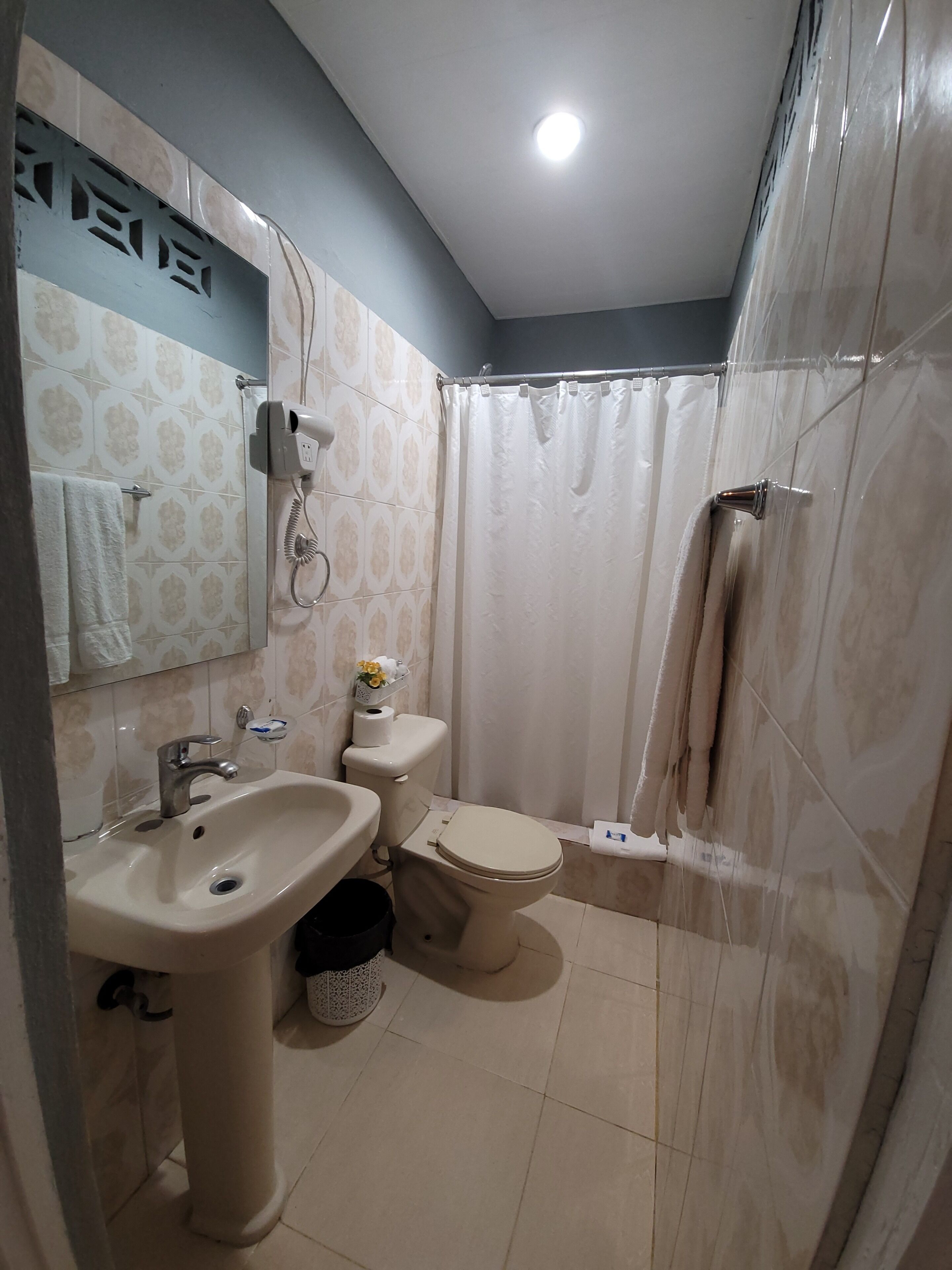 A bathroom with a sink, toilet, and shower.