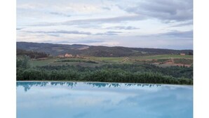 A landscape with a body of water reflecting the sky and surrounding greenery. - Quercia Al Poggio (Barberino Tavarnelle)