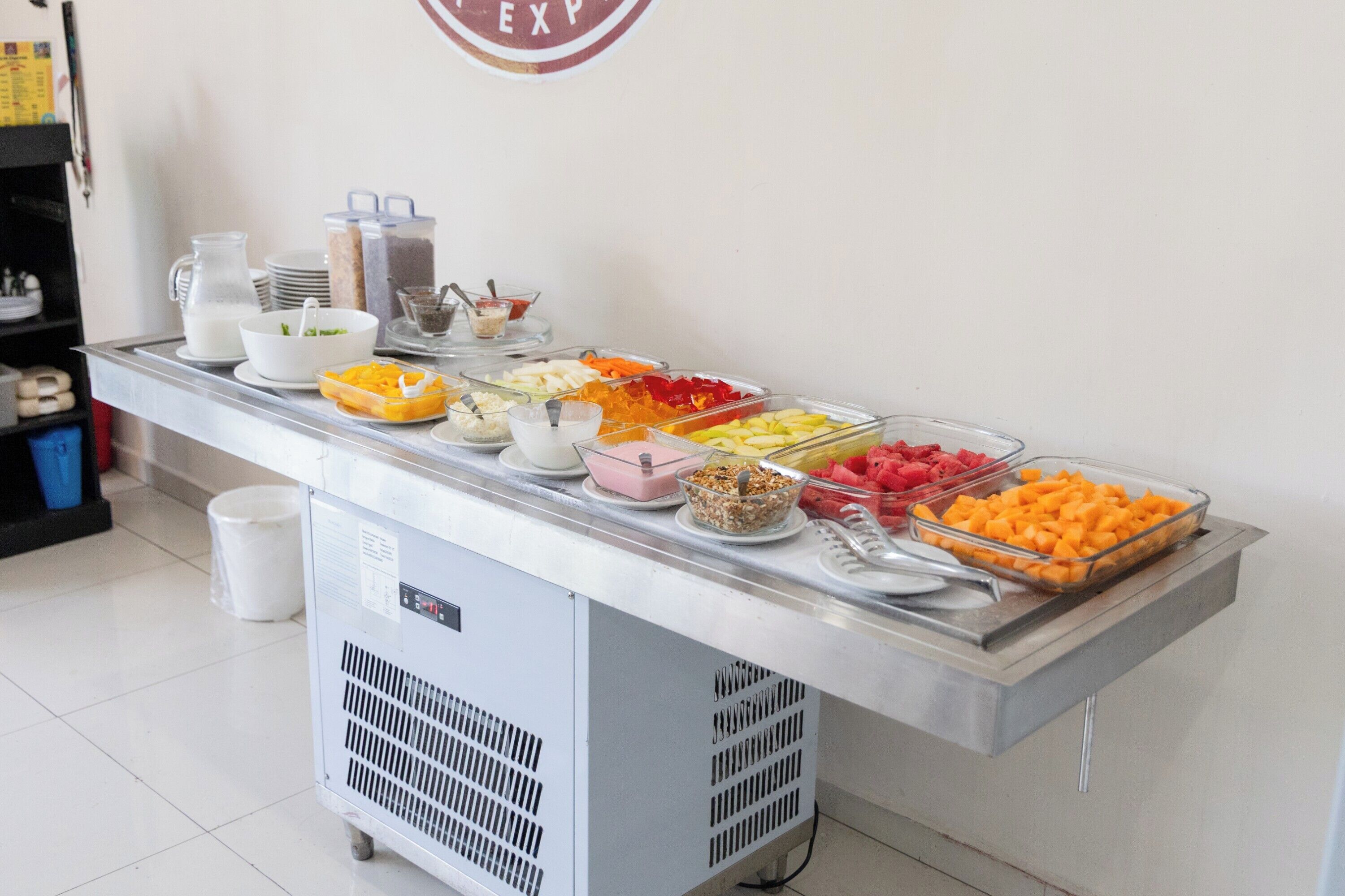A buffet with various food items and condiments.