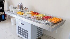 A buffet with various food items and condiments.