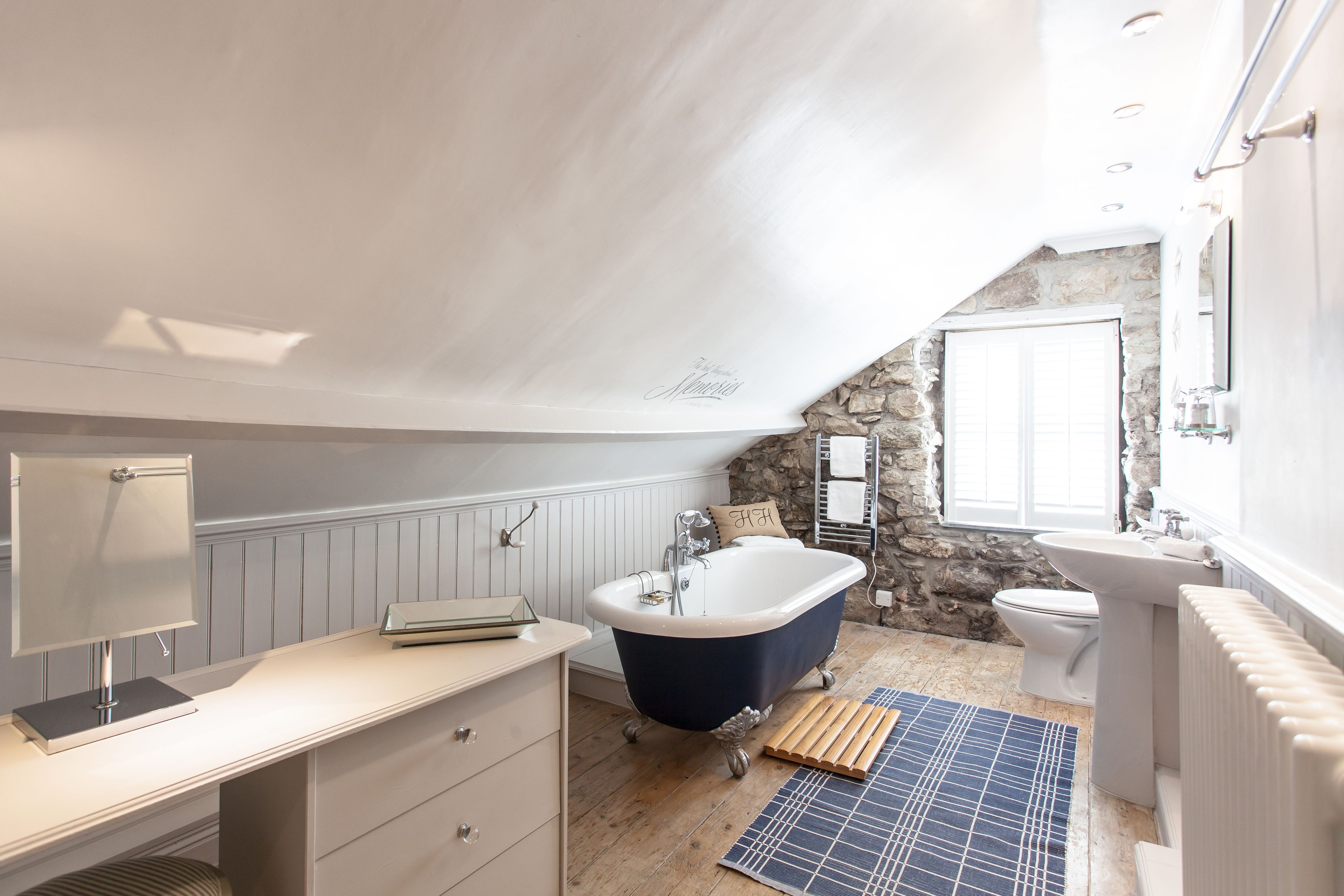 A bathroom with a bathtub, toilet, and sink.