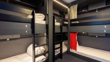 A bunk room with labeled beds D, C, H, and G, and a ladder for access.