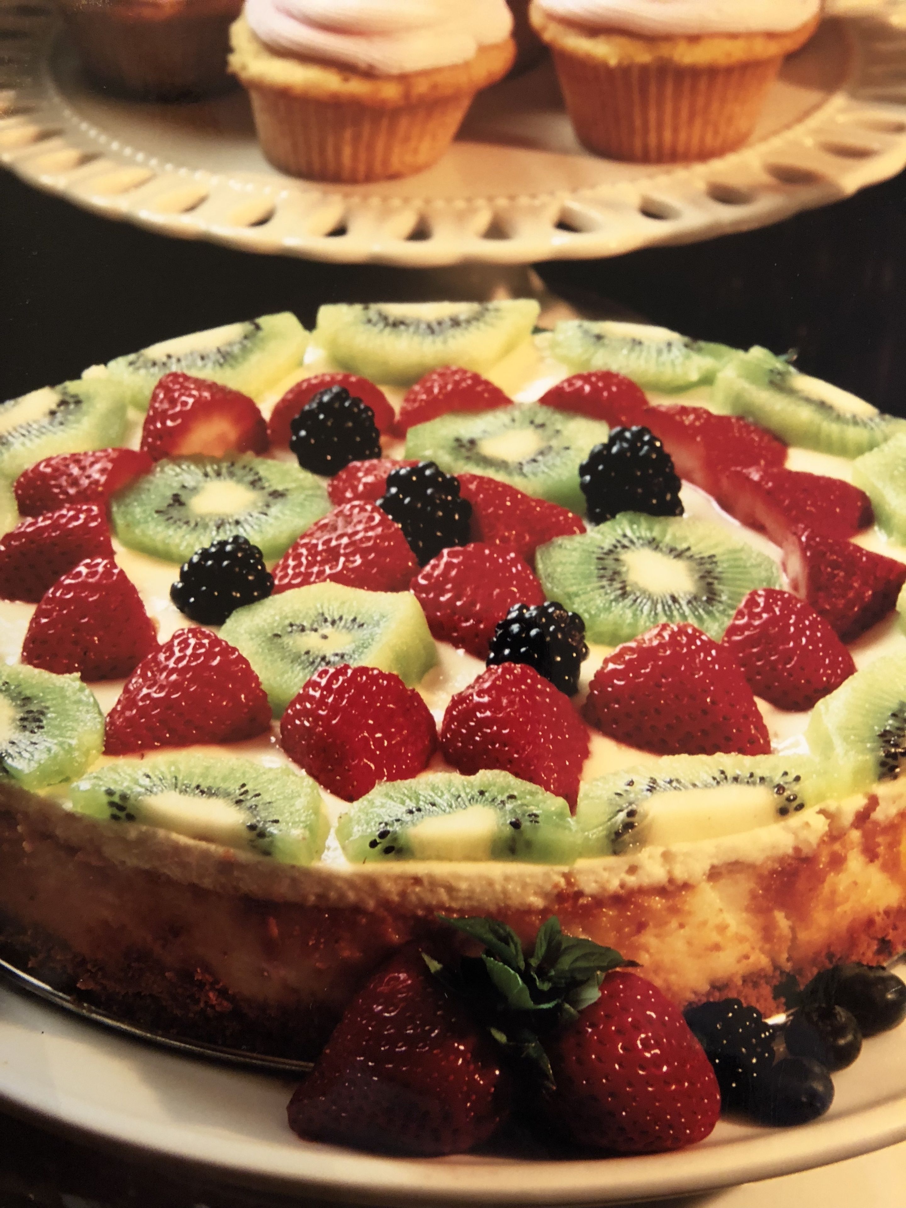 A fruit-topped dessert on a plate.